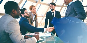 2 man shaking hands in company office