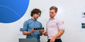 A sales rep standing and explaining product to a prospect