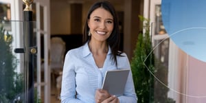 Woman holding tablet and smiling at camera 
