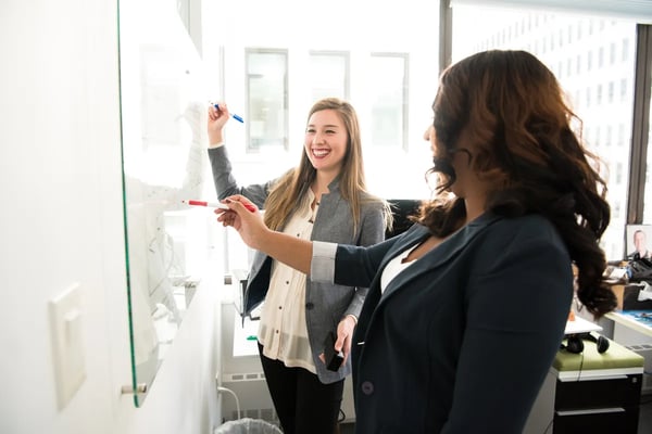 Retorio 2 women at a whiteboard