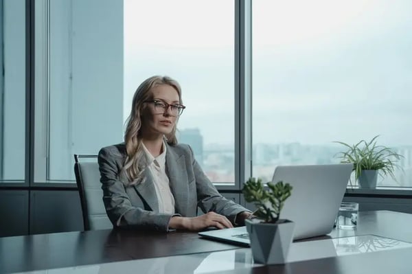 Woman sitting at desk with laptop in front of her