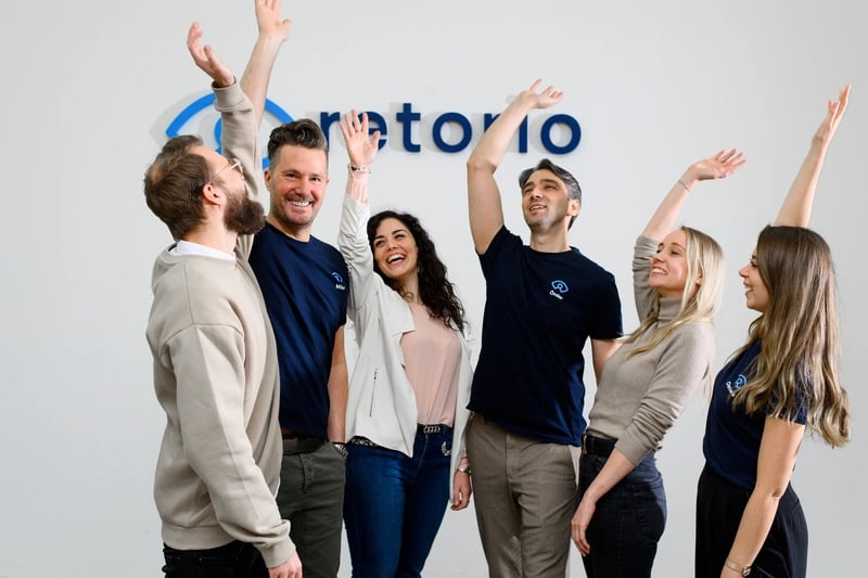 Retorio Employee life cycle group photo with arms up in the air 