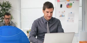 man working on his laptop with office background