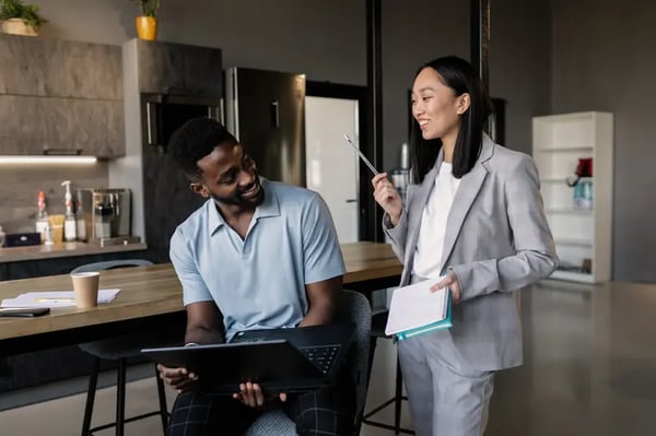 Two employees smiling and looking at each other