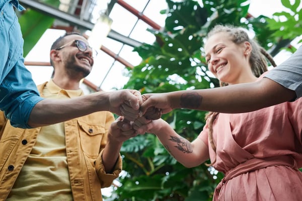 Retorio group of employees fist bumping