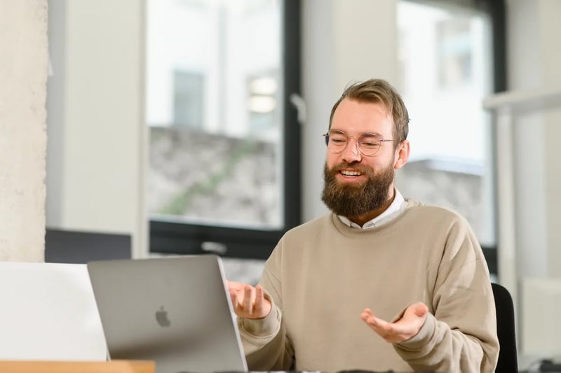 Retorio man sitting at a desk looking at laptop