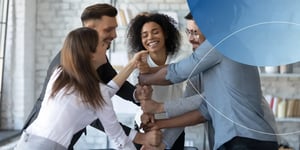 Employees performing teamwork in the office while being happy