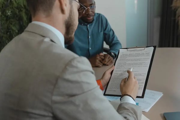 Two male employees discussing feedback in office table