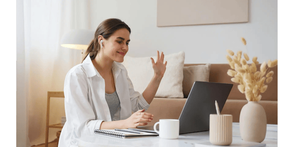 Employee taking online coaching in her home in front of computer