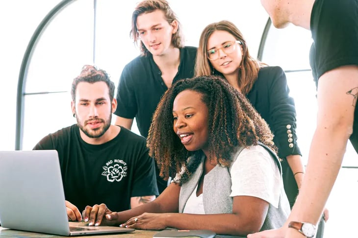 group looking at a laptop