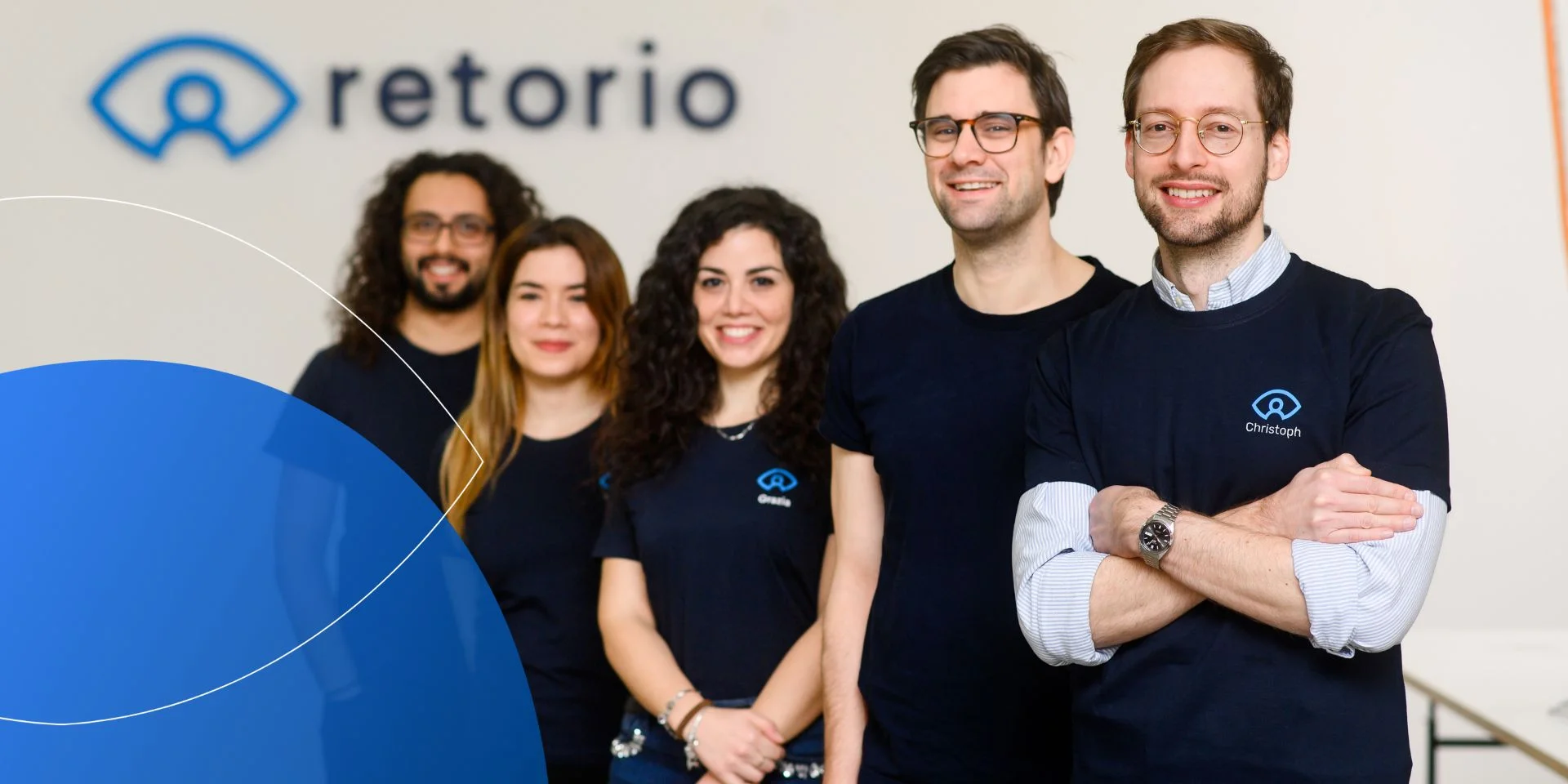 five people standing together smiling into camera 