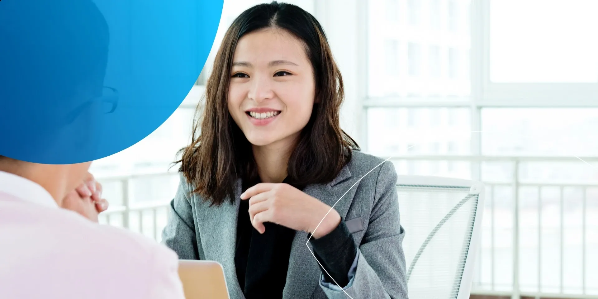 woman smiling to a person in front of her 